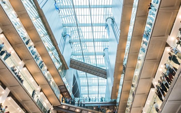Image of the Crick with researchers lining the walkways. 