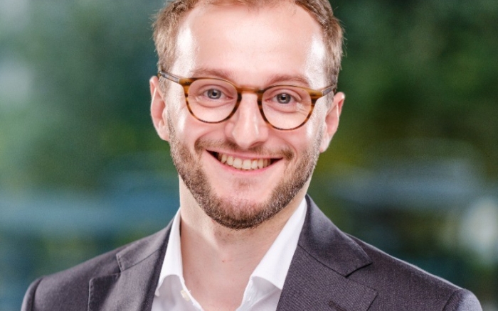 A man smiles at a camera