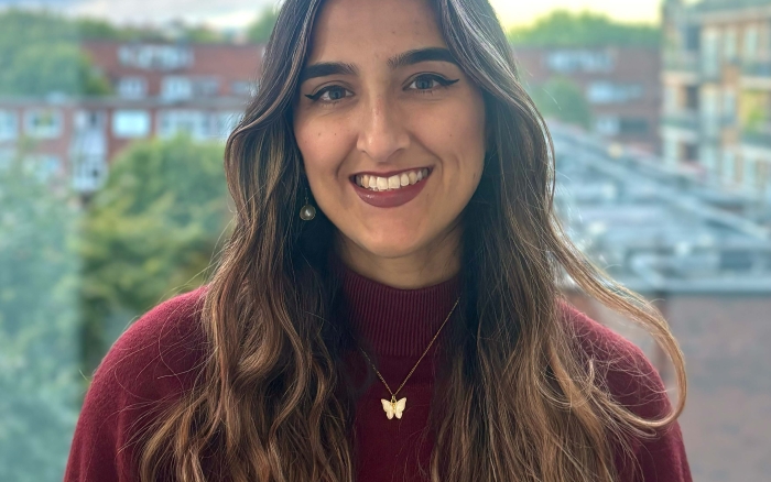 A woman smiles at the camera