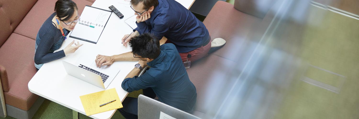 Students working in a collaboration space at the Crick.