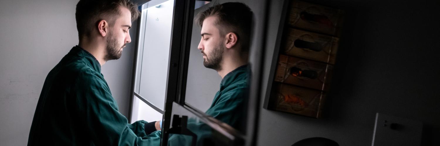 Researcher sitting at fume hood 