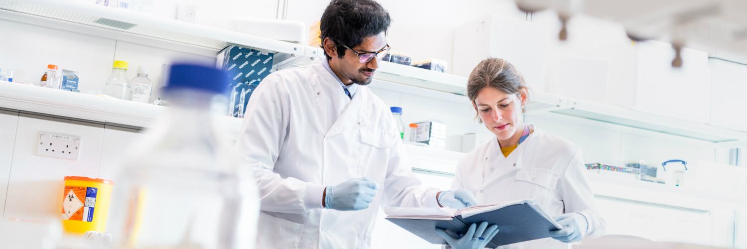 Two researchers in discussion in lab