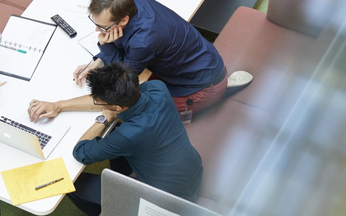 three people collaborating from above