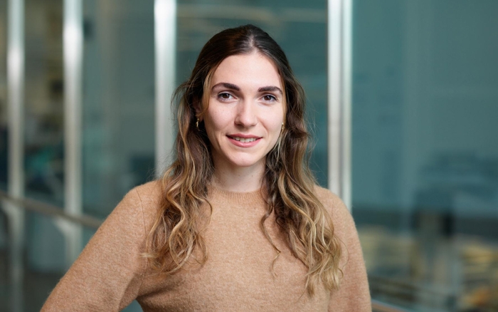 A woman smiles at the camera